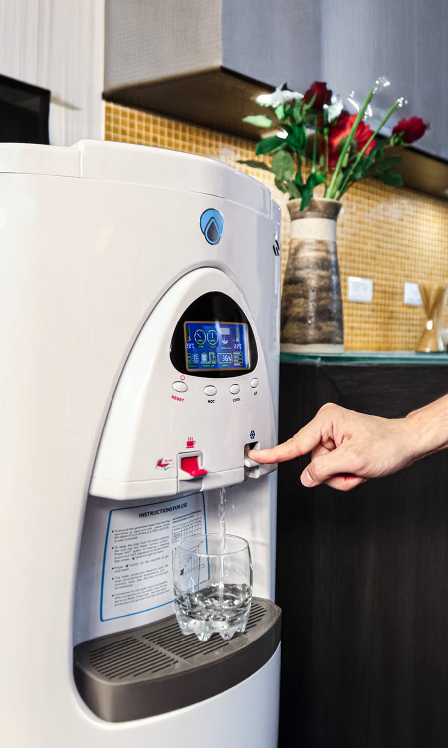 MUZN dispensing fresh, mineralized water into a glass at home